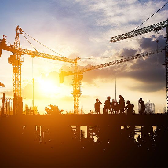 Construction crew at sunset
