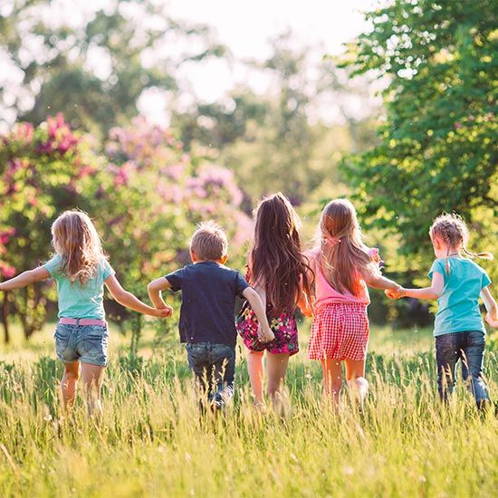 Group of playing kids in field